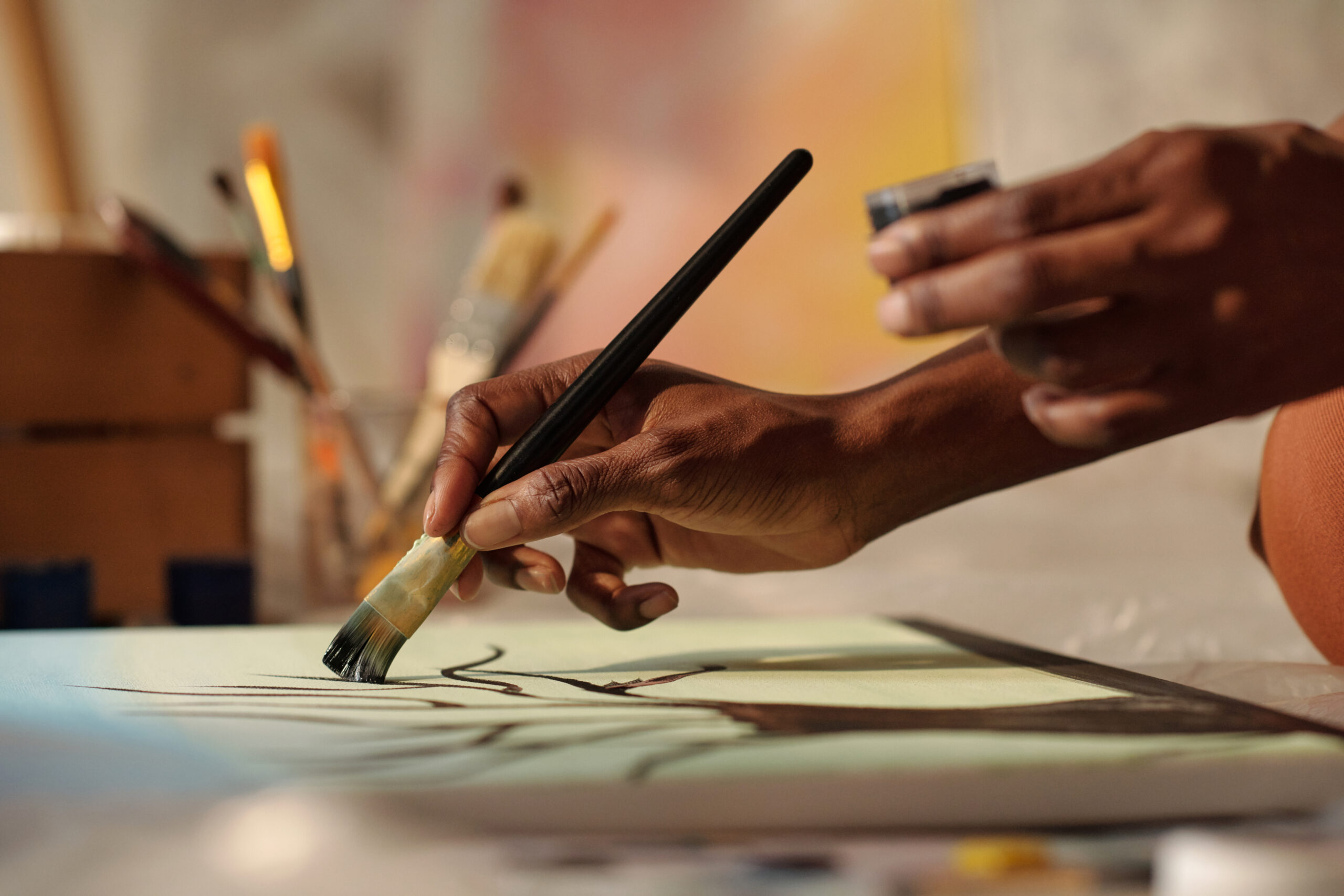 Painter Creating Artwork With Brushes Holding Paint